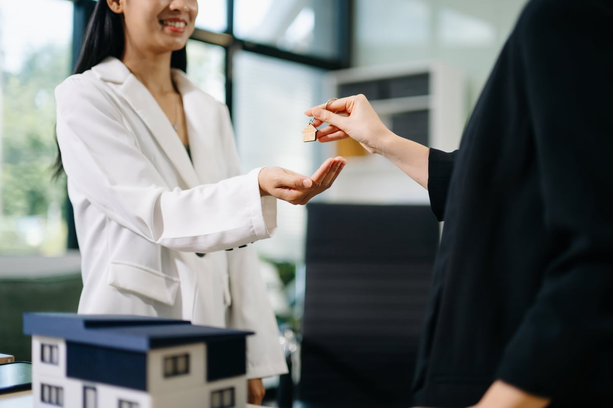 Real estate agent handing over house keys to a guest at a vacation rental